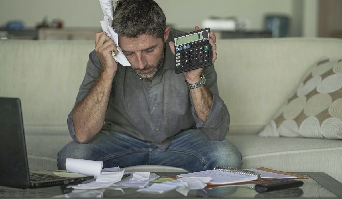 man-overwhelmed-by-taxes-doesnt-know-how-to-hold-calculator.jpg